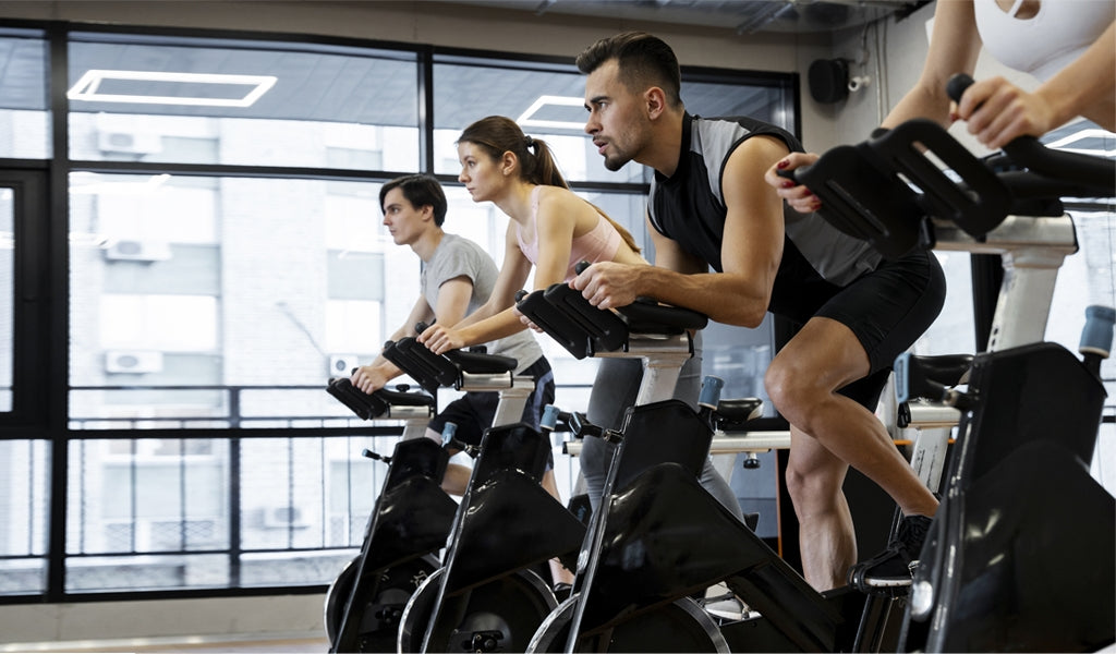 Multiple people using bikes in gym