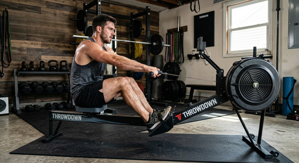 Someone mid-interval on a Throwdown HIIT Rower in home gym