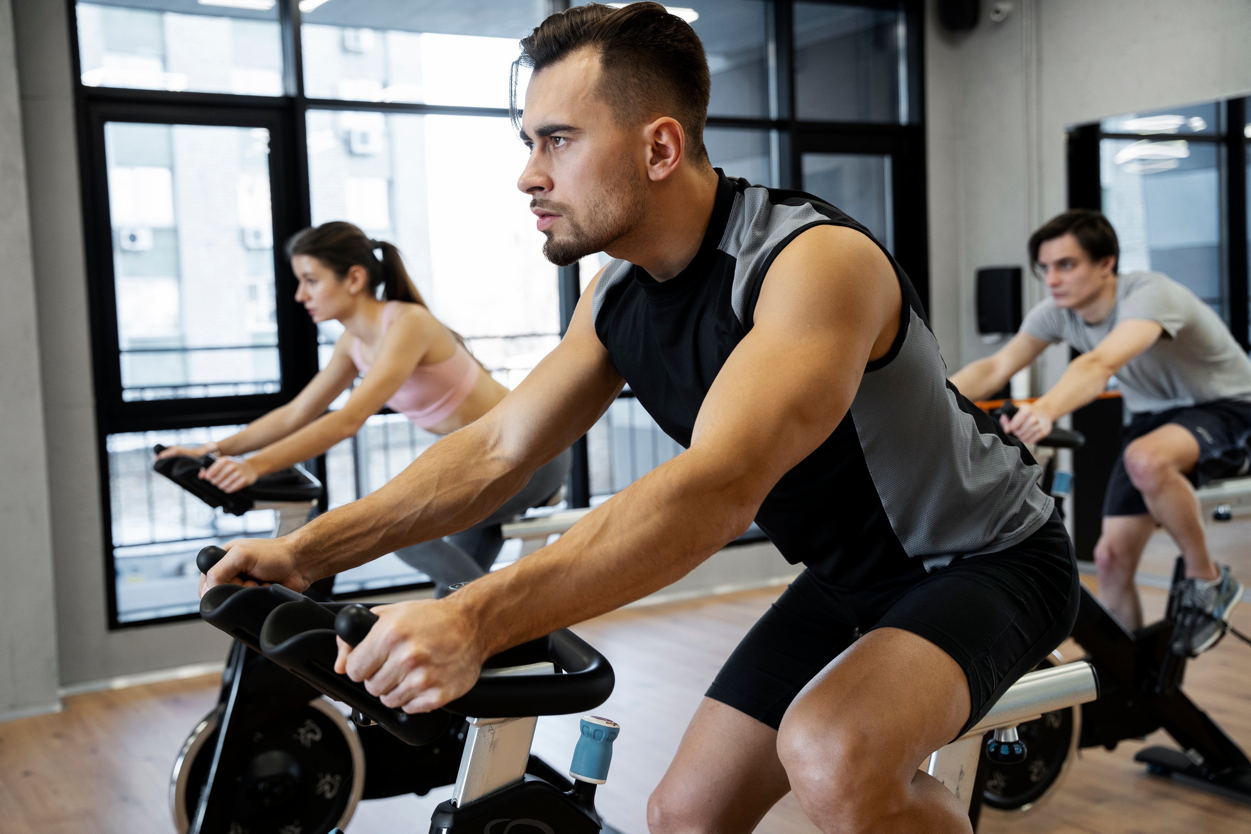 People on indoor cycling bikes