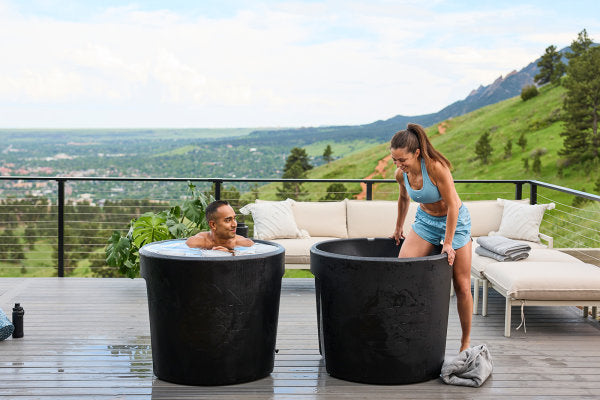 Two people using cold plunge tubs 